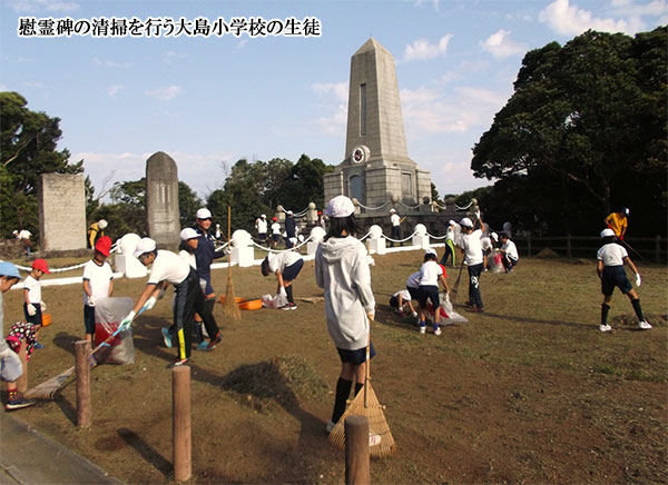 慰霊碑の清掃を行う大島小学校の生徒の写真