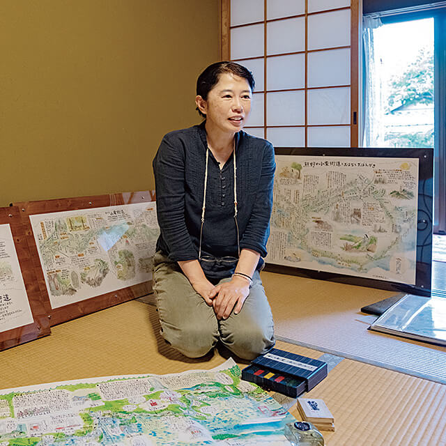 作品を広げて古道を紹介する生駒さん